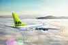 AirBaltic passenger aircraft flying above a layer of clouds under a pale blue sky.