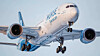 Norse Atlantic Airways passenger jet viewed from below against a pale blue sky