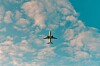 **A small airplane is seen against a cloudy blue sky.**
