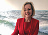 Anna Grönlund in a red jacket beside a sea scene and an electric bus image.