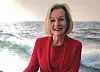 Anna Grönlund in a red jacket beside a sea scene and an electric bus image.