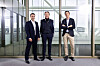 Michel Thomas, Per G Braathen and Eric Matsgård standing together in a modern glass office.