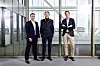Michel Thomas, Per G Braathen and Eric Matsgård standing together in a modern glass office.
