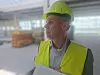 Paul Verhagen wearing a hard hat and high-visibility vest at an industrial site.